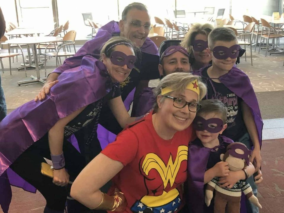 Volunteers dressed in DSF Purple capes